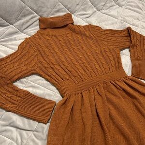Stretchy sweater dress. Cooper color, cable knit front. Subtle feminine pleats.